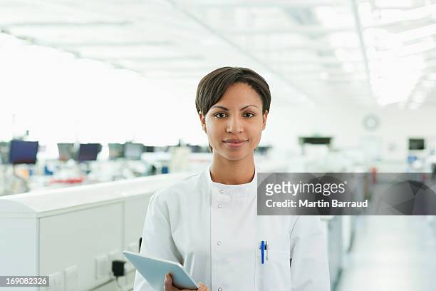scientist holding tablet computer in lab - woman scientist bildbanksfoton och bilder