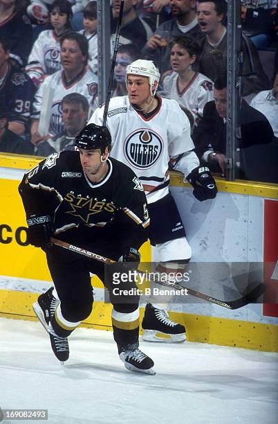 Darryl Sydor of the Dallas Stars skates away from German Titov of the Edmonton Oilers during Game 3 of the 2000 Conference Quarter-Finals on April...