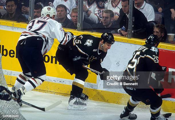 Darryl Sydor of the Dallas Stars is checked by Dan Cleary of the Edmonton Oilers during Game 3 of the 2000 Conference Quarter-Finals on April 16,...