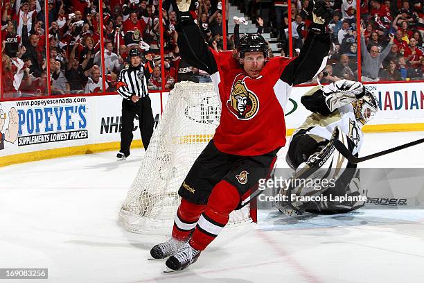 Daniel Alfredsson of the Ottawa Senators celebrates his game tying goal as Tomas Vokoun of the Pittsburgh Penguins reacts in Game Three of the...