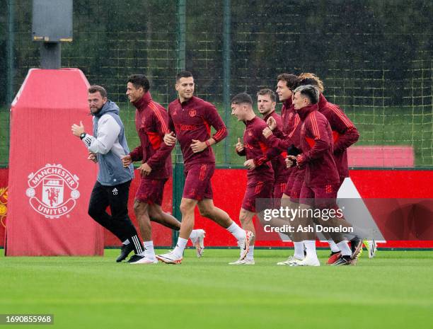 Lisandro Martinez, Dan Gore, Diogo Dalot and Raphael Varane of Manchester United in action during a Manchester United Training Session at Carrington...