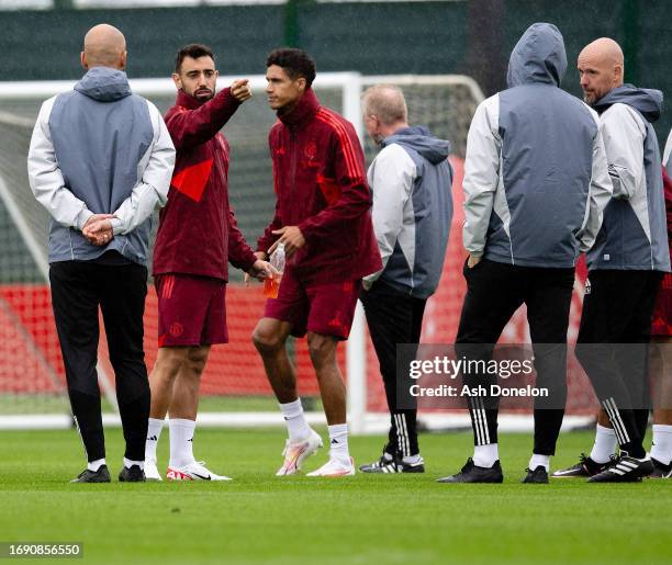 Bruno Fernandes and Raphael Varane of Manchester United in action during a Manchester United Training Session at Carrington Training Ground on...