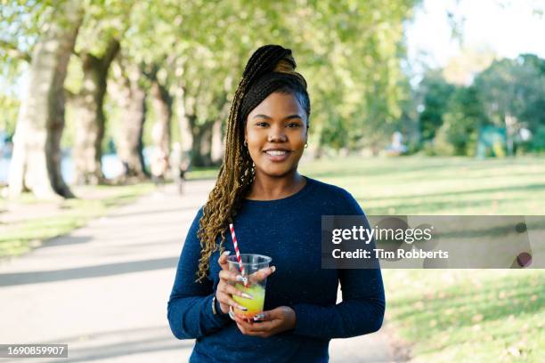 woman with cold drink looking at camera - slushies stock pictures, royalty-free photos & images