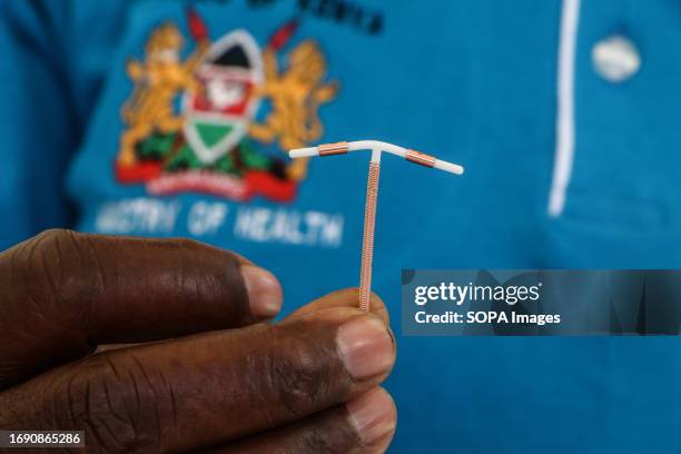Close-up of a hand holding an Intrauterine Contraceptive Device in the Uterus during the national celebrations of The World Contraception Day....