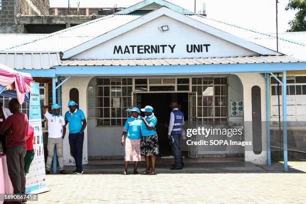 People stand in front of a maternity unit during the national celebrations of The World Contraception Day. According to data from Kenya Demographic...