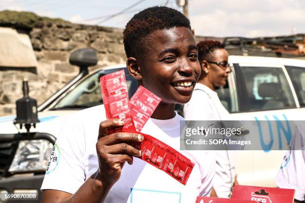 Volunteer displays men condoms during the national celebrations of The World Contraception Day. According to data from Kenya Demographic and Health...