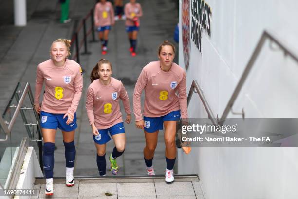 Katie Robinson, Jess Park and Lucy Parker walk out prior to a training session at St George's Park on September 19, 2023 in Burton upon Trent,...