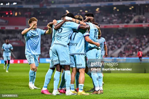 Keito NAKAMURA of Reims celebrates his goal with Thomas FOKET of Reims, Marshall MUNETSI of Reims and Teddy TEUMA of Reims during the French Ligue 1...