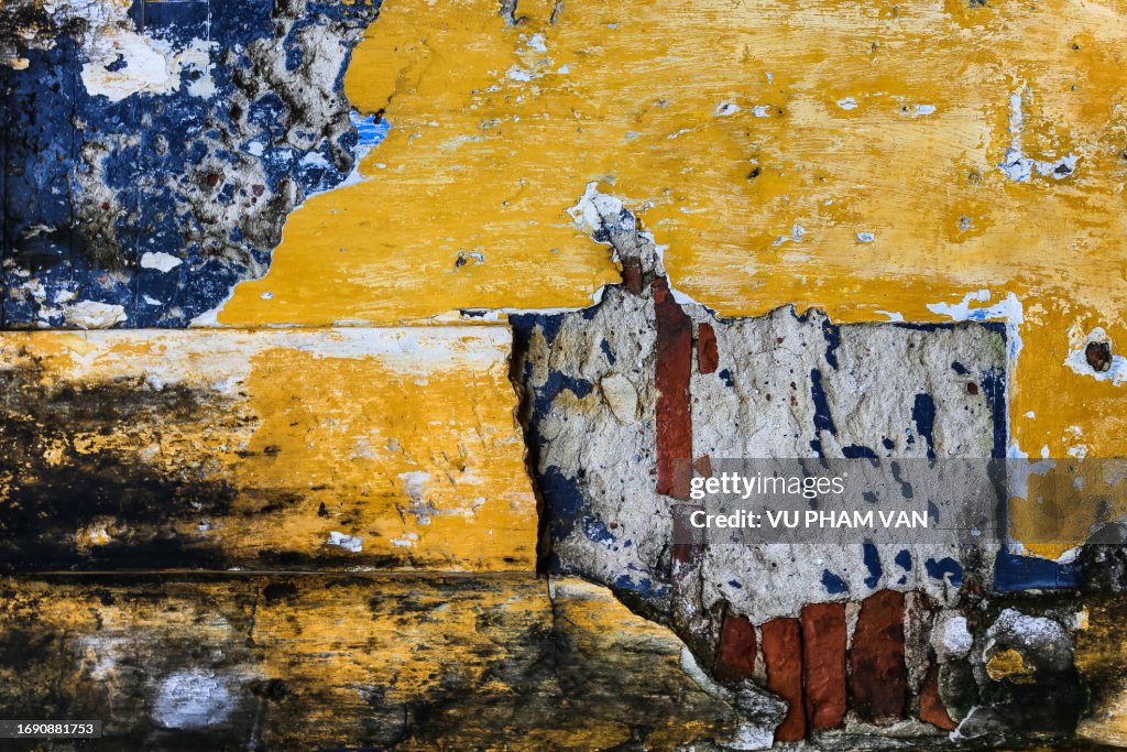 Peeled yellow wall with multi-layered paint