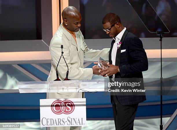 Former pro basketball player Gary Payton presents Pro basketball player Chris Paul his award onstage at the 28th Anniversary Sports Spectacular Gala...