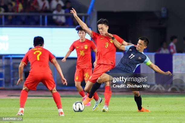 Sunil Chhetri of India competes for the ball with Jiang Shenglong of China during the 19th Asian Game Men Group A match between China and India at...