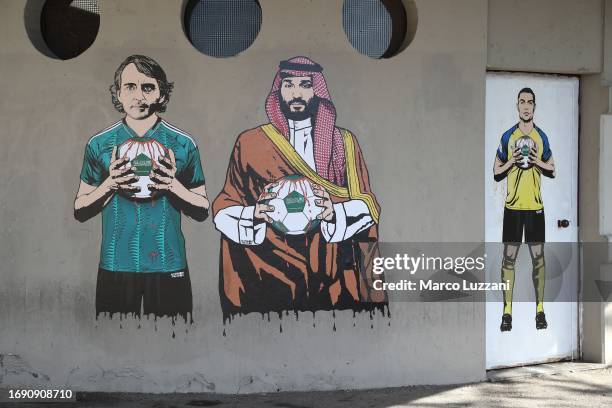 Mural depicting Roberto Mancini, Mohammed bin Salman and Cristiano Ronaldopainted by aleXsandro Palombo outside the San Siro Stadium before the UEFA...