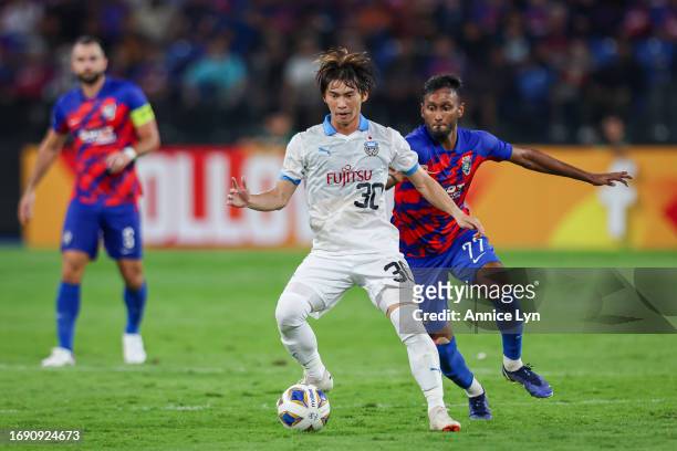 Mohamed Syamer Kutty of Johor Darul Ta'zim competes for the ball against Yusuke Segawa of Kawasaki Frontale during the second half of the AFC...