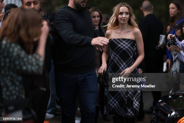 Jodie Comer was seen wearing a black and white strapless Burberry dress as well as a black bag during London Fashion Week September 2023 at the...