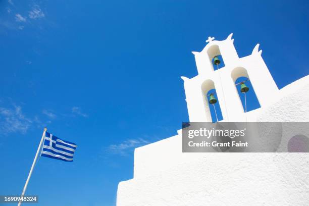 bell tower and flag post. - greek orthodoxy stockfoto's en -beelden