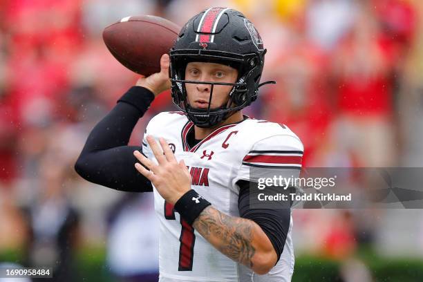 Spencer Rattler of the South Carolina Gamecocks passes during the first half against the Georgia Bulldogs at Sanford Stadium on September 16, 2023 in...