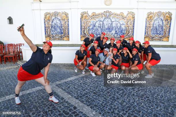 Angel Yin takes a selfie of herself with The United States team with their captain Stacy Lewis and her husband and daughter behind during the...