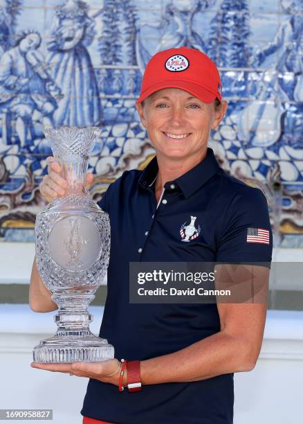 Stacy Lewis the captain of The United States Team poses with teh Solheim Cup during the official photo-call as a preview for the The Solheim Cup at...