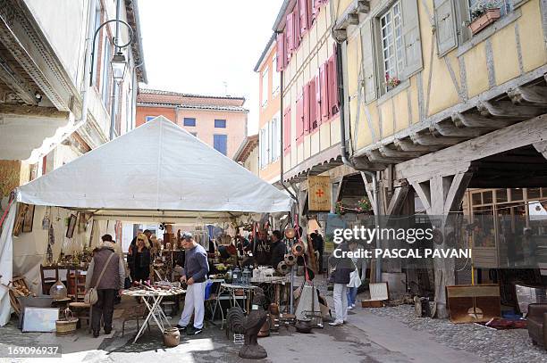 People look at ancient items displayed as part of a second-hand market on May 19, 2013 in Mirepoix, south western France. AFP PHOTO/PASCAL PAVANI