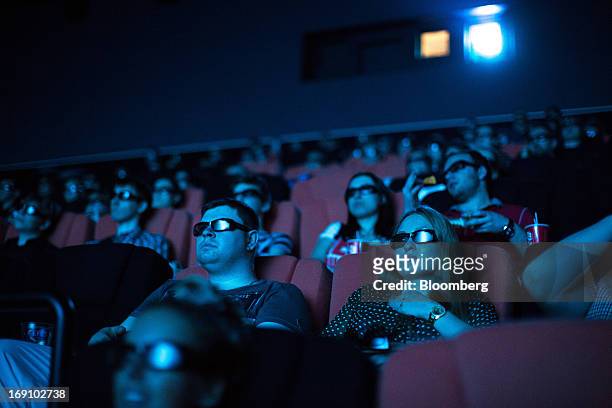 Audience members wear 3D spectacles to watch a movie at the Cinema Park multiscreen theatre complex at the Metropolis Shopping and Entertainment Mall...