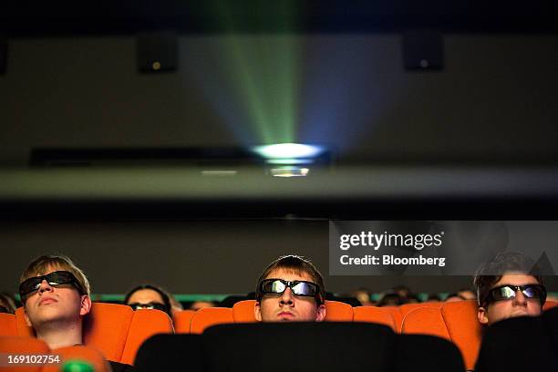 Audience members wear 3D spectacles to watch a movie at the Cinema Park multiscreen theatre complex at the Metropolis Shopping and Entertainment Mall...