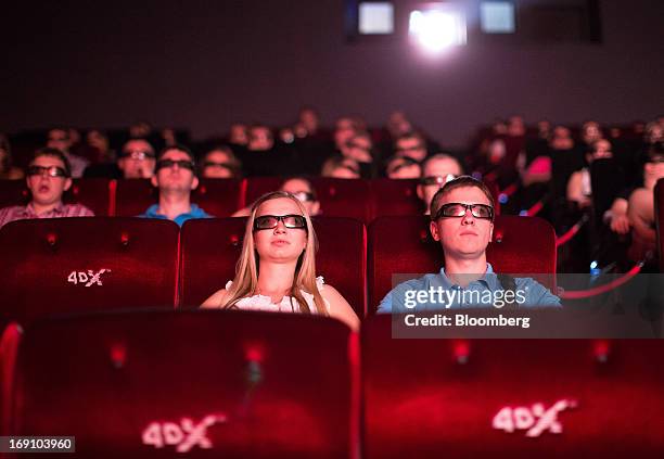 Audience members wear 3D spectacles to watch a movie using 4DX motion picture technology at the Cinema Park multiscreen theatre complex operated by...