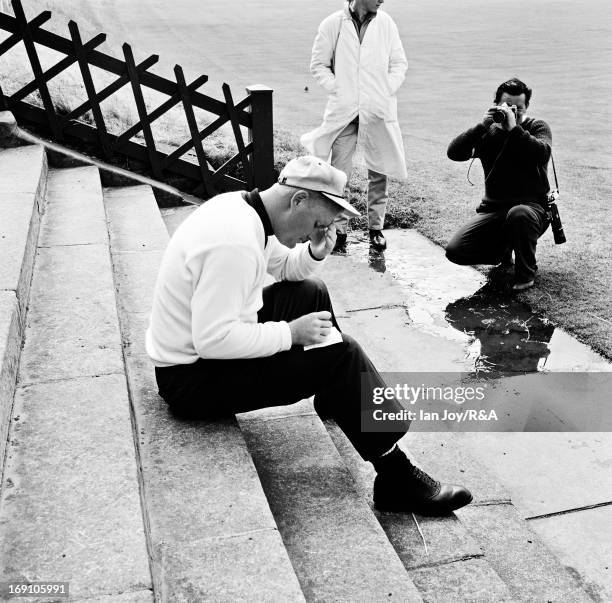 Jack Nicklaus of the USA signs his card on the steps beside the 18th green after finishing second during the final round of the Open Championship on...
