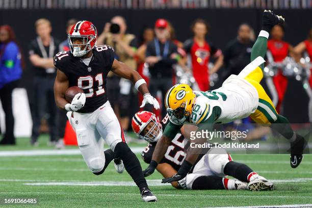 Jonnu Smith of the Atlanta Falcons rushes after a reception as Colby Wooden of the Green Bay Packers is blocked by Matthew Bergeron during the third...