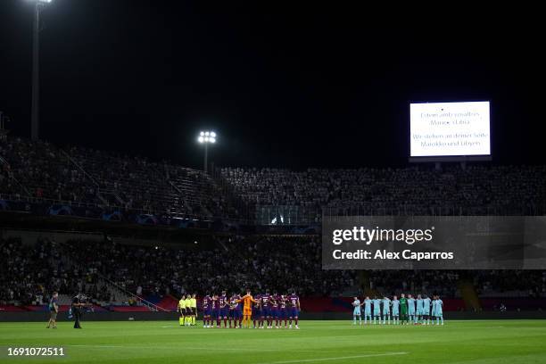 The players of Barcelona and Royal Antwerp line up for a minute's silence in respect of the natural disasters taking place in Morocco and Libya prior...