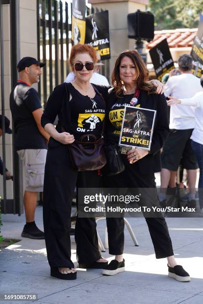 Lisa Ann Walter and Joely Fisher walk the picket line at the SAG-AFTRA strike on September 26, 2023 at Warner Brothers Studios in Burbank, California.