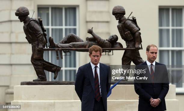 The Duke of Cambridge, Prince William and Prince Harry stand in front of the Help for Heroes statue as they officially open the charity's Tedworth...