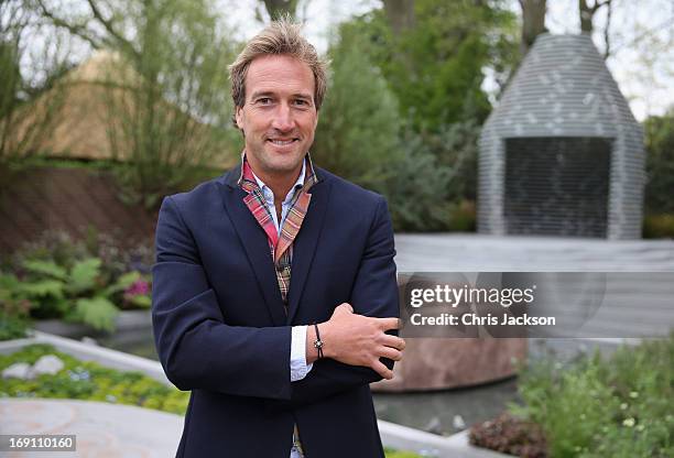 Ben Fogle wears the Garrard 'Sentebale' bracelet as he poses in the B&Q Sentebale 'Forget-Me-Not' Garden at the Chelsea Flower Show at Royal Hospital...