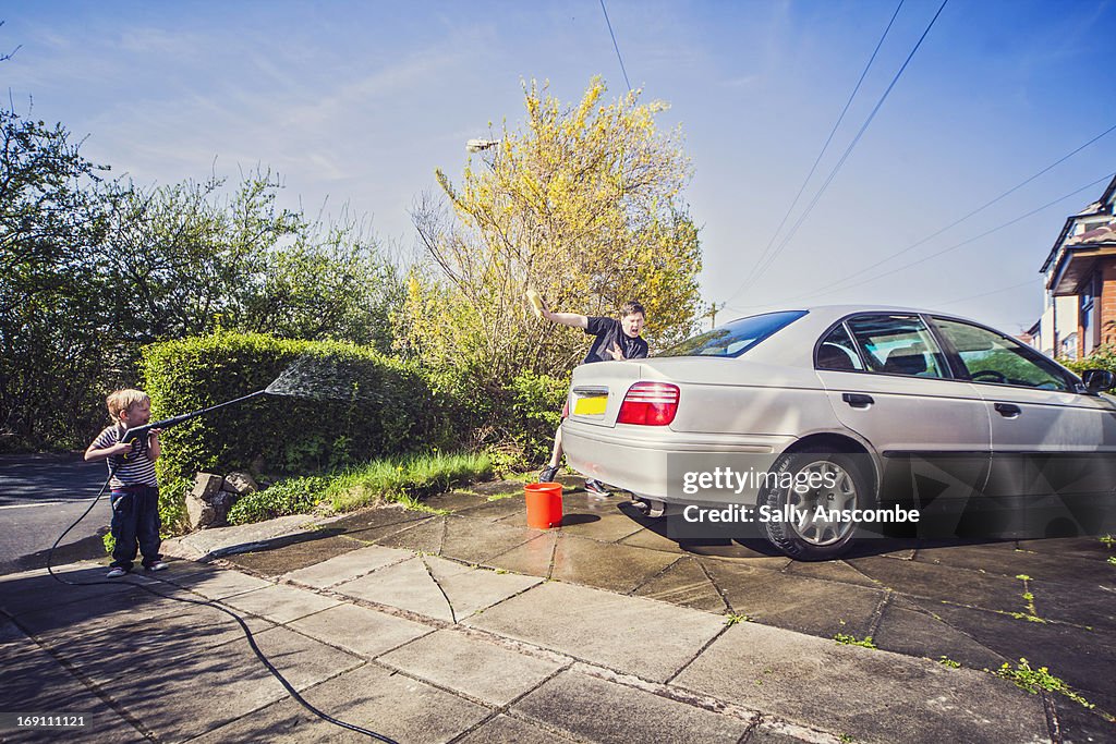 Father and son washing the car together