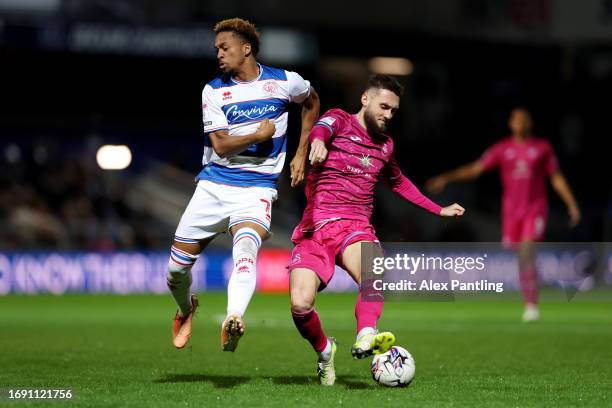 Matt Grimes of Swansea City is challenged by Chris Willock of Queens Park Rangers during the Sky Bet Championship match between Queens Park Rangers...