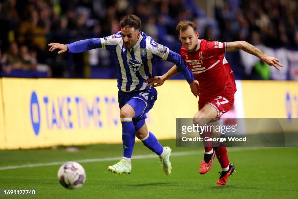 Pol Valentin of Sheffield Wednesday is challenged by Alex Gilbert of Middlesbrough during the Sky Bet Championship match between Sheffield Wednesday...