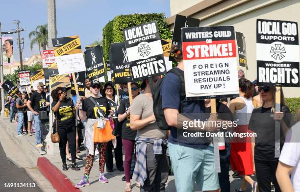 Protesters join the picket line outside Paramount Studios on September 19, 2023 in Los Angeles, California. Members of SAG-AFTRA and WGA have both...