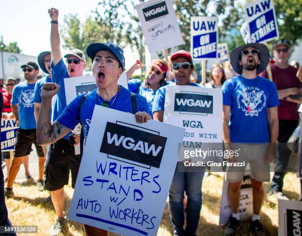 Members of the Writers Guild of America West join striking United Auto Workers at a rally in front of the Stellantis Mopar facility on September 26,...