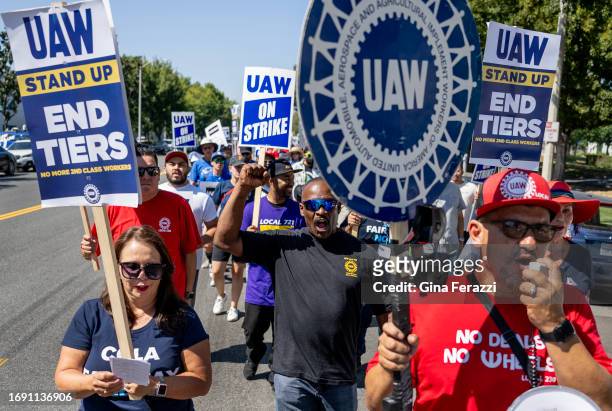Striking United Auto Workers march in front of the Stellantis Mopar facility on September 26, 2023 in Ontario, California. They are striking to get a...