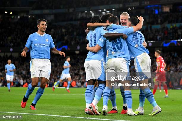 Julian Alvarez of Manchester City celebrates with teammates after scoring the team's first goal during the UEFA Champions League Group G match...