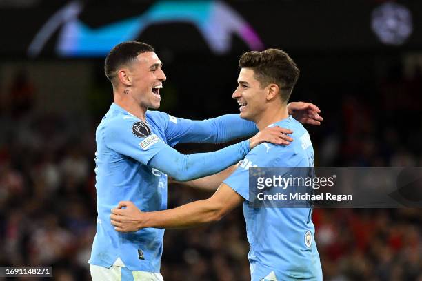 Julian Alvarez of Manchester City celebrates with teammate Phil Foden after scoring the team's second goal during the UEFA Champions League Group G...