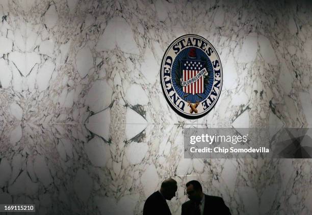 Sen. Charles Schumer talks with one of his staff members during a markup session for the immigration reform legislation now before the Senate...