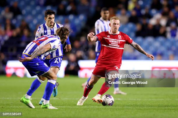 Lewis O'Brien of Middlesbrough runs with the ball under pressure from John Buckley of Sheffield Wednesday during the Sky Bet Championship match...