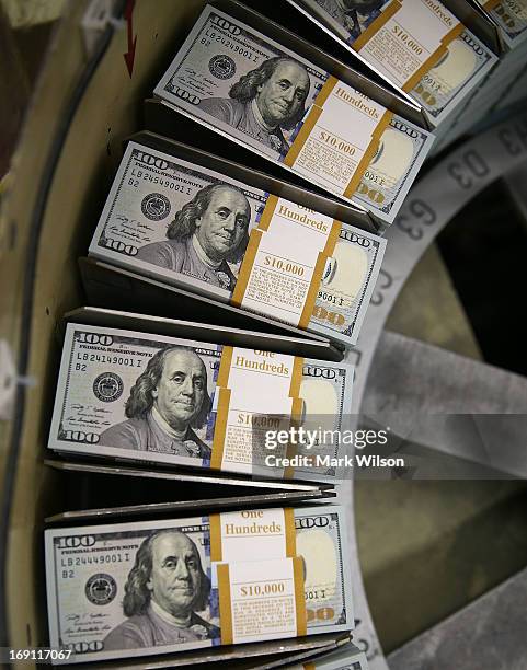 Newly redesigned $100 notes are printed at the Bureau of Engraving and Printing on May 20, 2013 in Washington, DC. The one hundred dollar bills will...