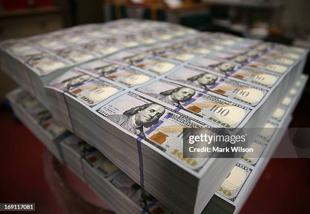 Newly redesigned $100 notes lay in stacks at the Bureau of Engraving and Printing on May 20, 2013 in Washington, DC. The one hundred dollar bills...