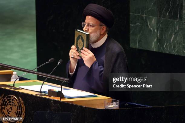 Iran's President Ebrahim Raisi holds the Koran as he address world leaders during the United Nations General Assembly on September 19, 2023 in New...