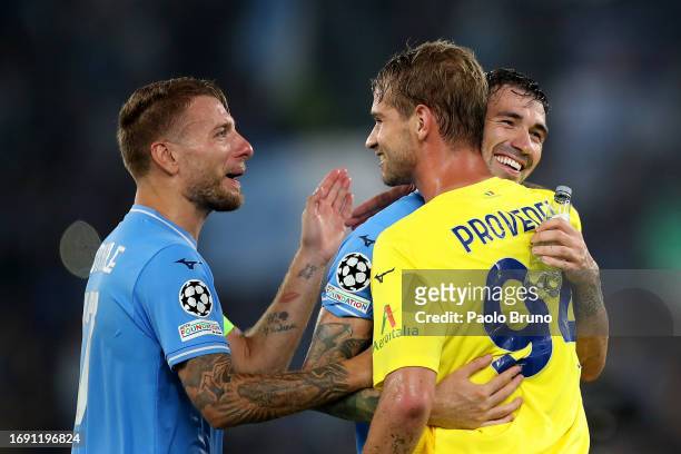 Dimitrije Kamenovic, Ivan Provedel, and Alessio Romagnoli of Lazio celebrate victory at full-time following the UEFA Champions League Group E match...