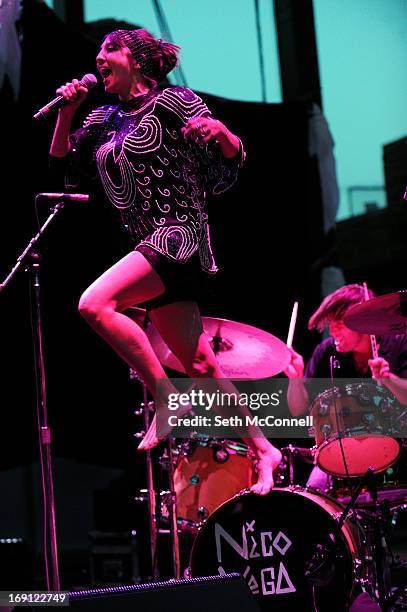 Nico Vega vocalist Aja Volkman leaps off of drummer Dan Epand's drums set while performing at Red Rocks Amphitheatre on May 16, 2013 in Morrison,...