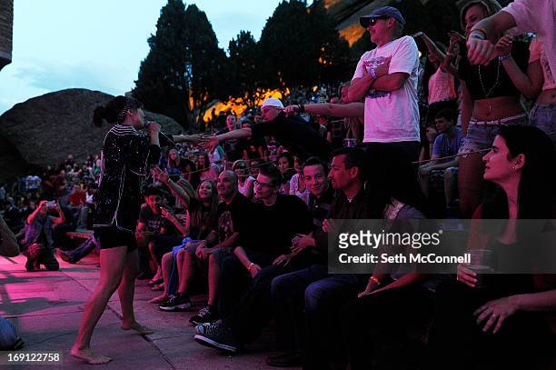 Nico Vega vocalist Aja Volkman shakes hands with audience members while performing at Red Rocks Amphitheatre on May 16, 2013 in Morrison, Colorado.