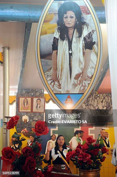 Faithful pray before an image of Aunt Neiva in a temple in Vale do Amanhecer , a mystical city four kilometres from Brasilia, on April 29, 2013. The...