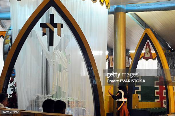 Faithful pray in a temple in Vale do Amanhecer , a mystical city four kilometres from Brasilia, on April 29, 2013. The Vale do Amanhecer is the...